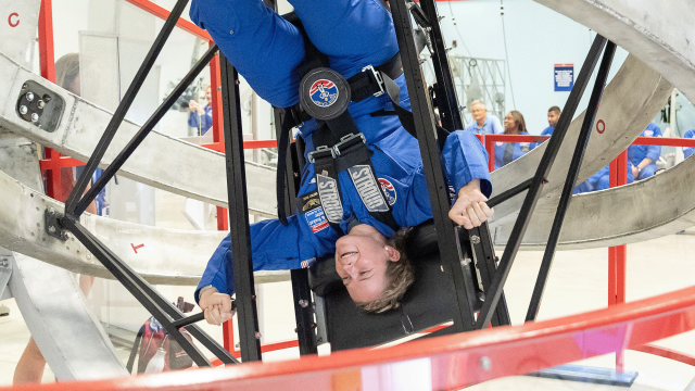 A trainee is spun upside down inside the Multi-Axis Trainer